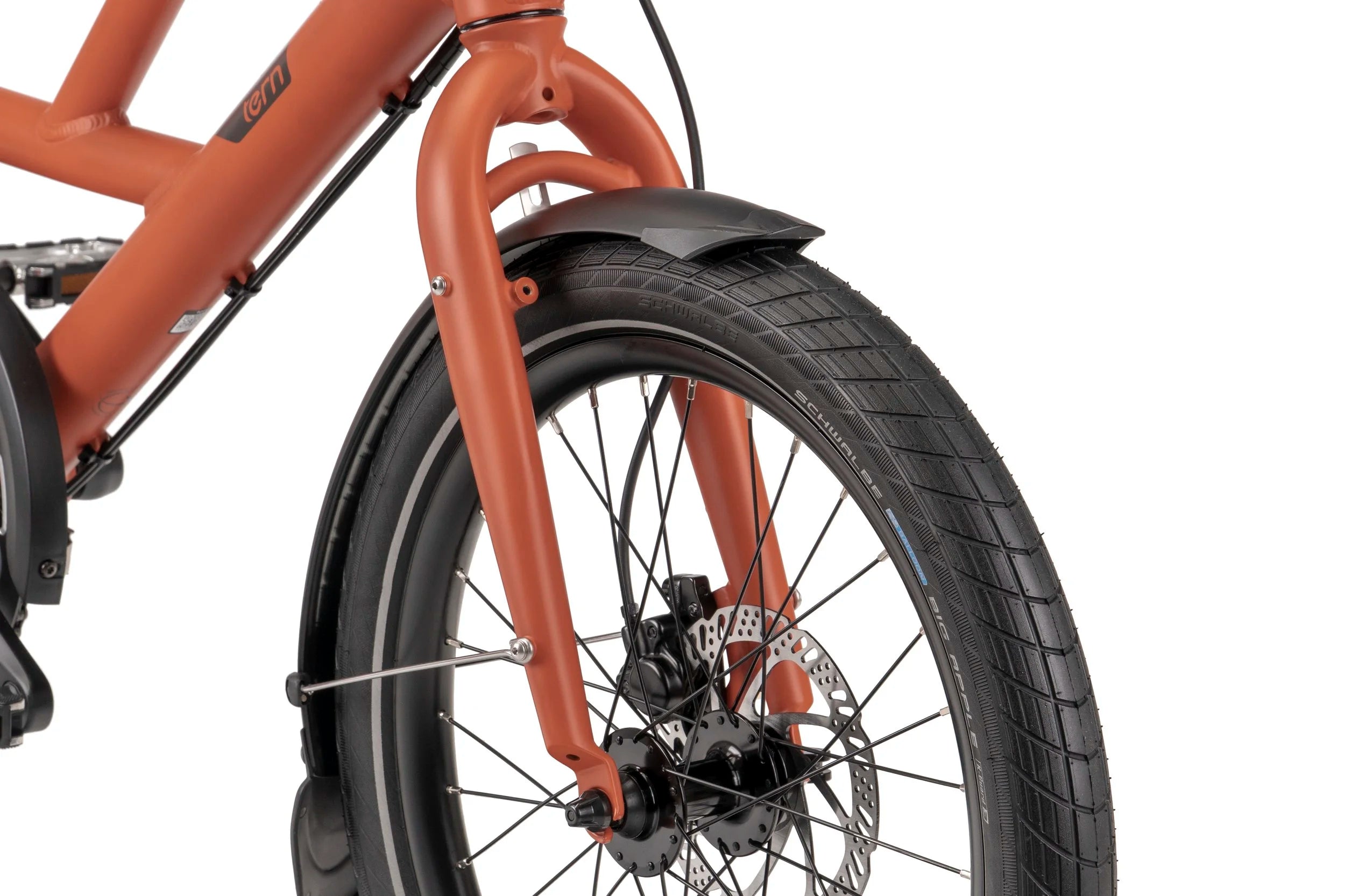 Close-up of a bicycle front wheel with red frame and black tire on a white background