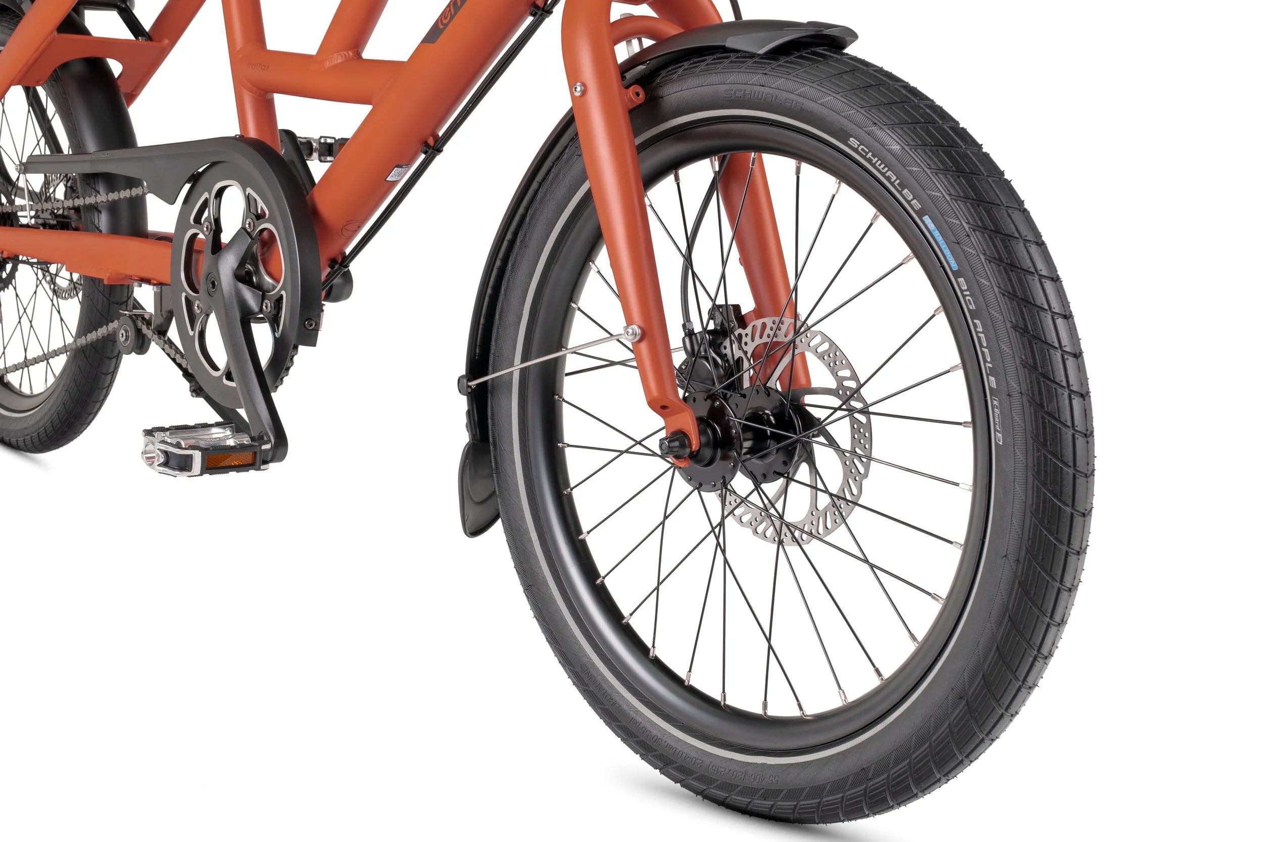 Close-up of a Tern bicycle front wheel and chain mechanism on a white background