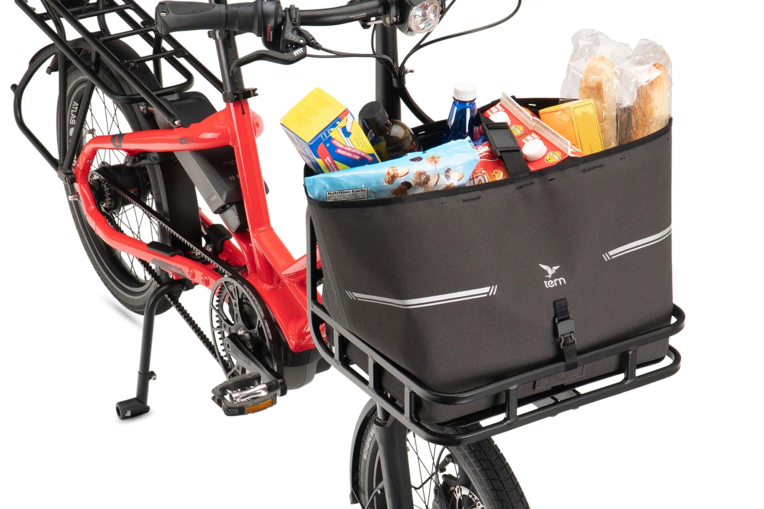 Black bicycle cargo basket attached to a red bike with various items inside on a white background