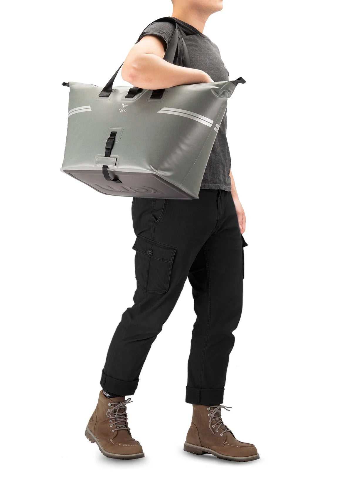 Person carrying a large gray pannier bag on a white background