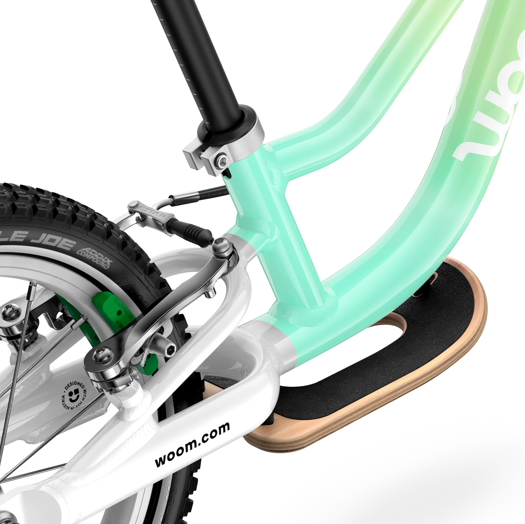 Close-up of a woom children's bike with a gradient green frame on a white background