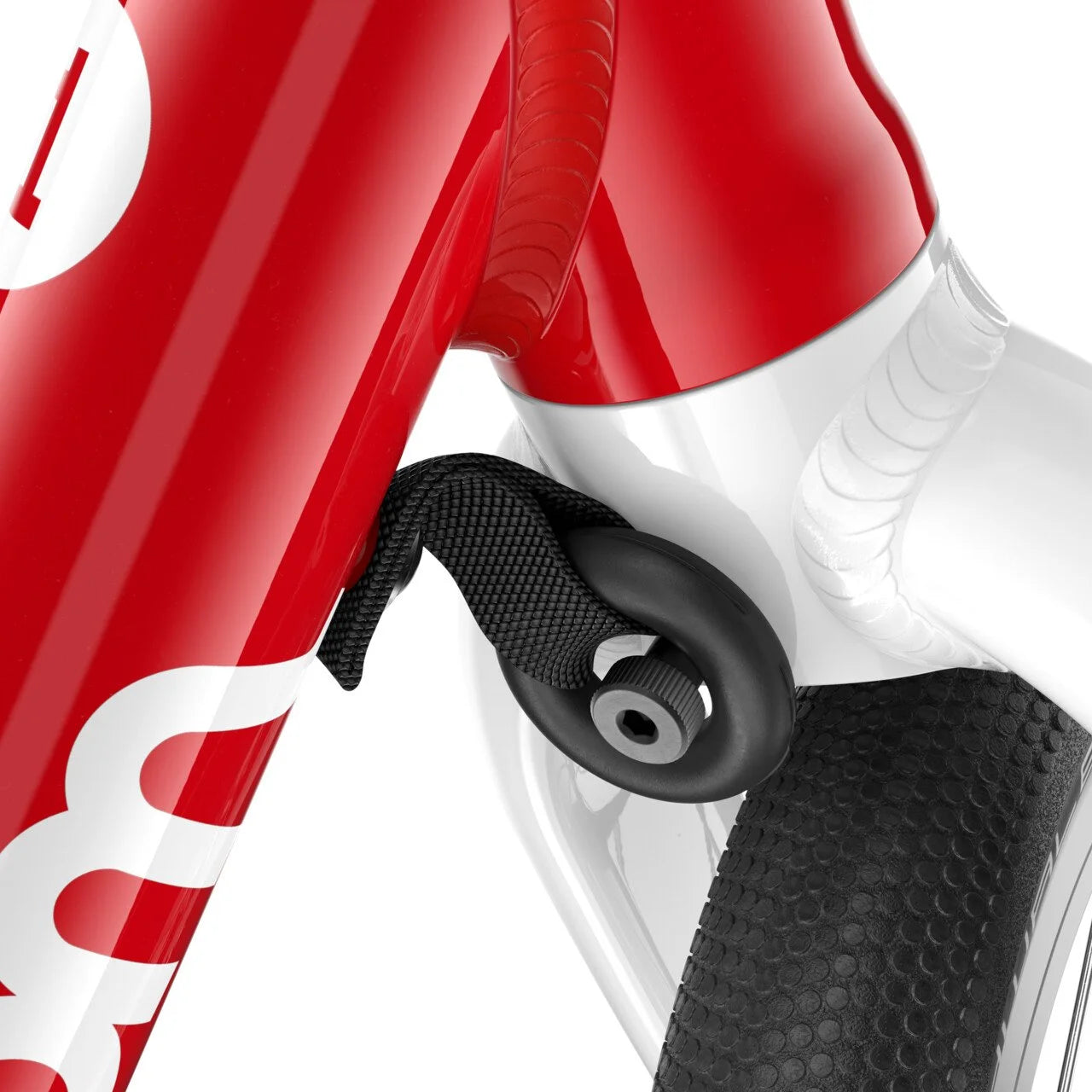 Close-up of a red and white Woom balance bike with a black wheel on a white background