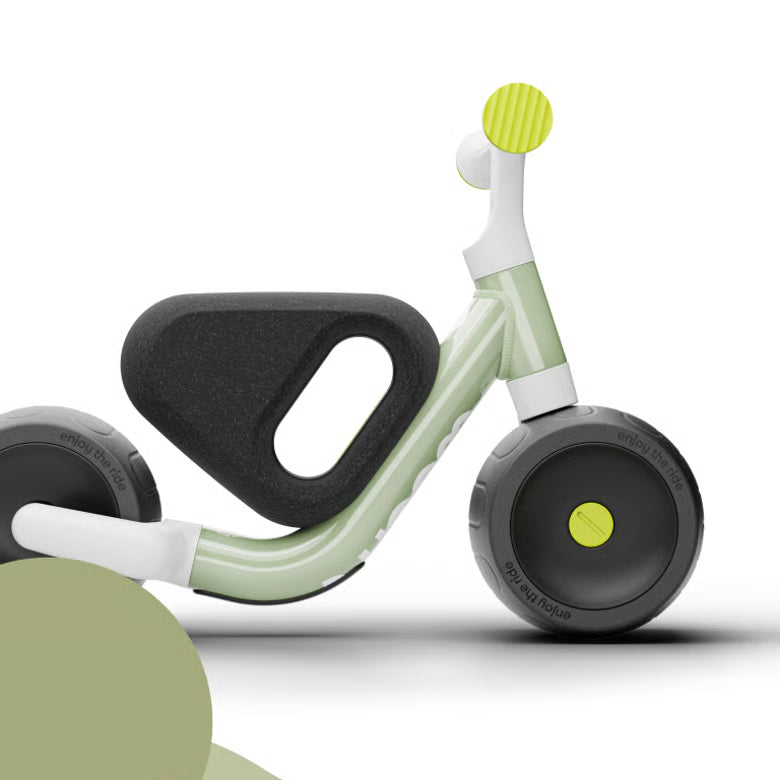 Children's balance bike with green and black design on a white background