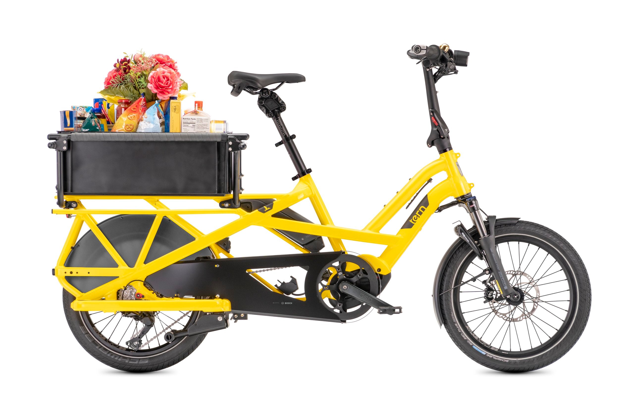 Yellow Tern cargo bike with a black box filled with groceries on a white background