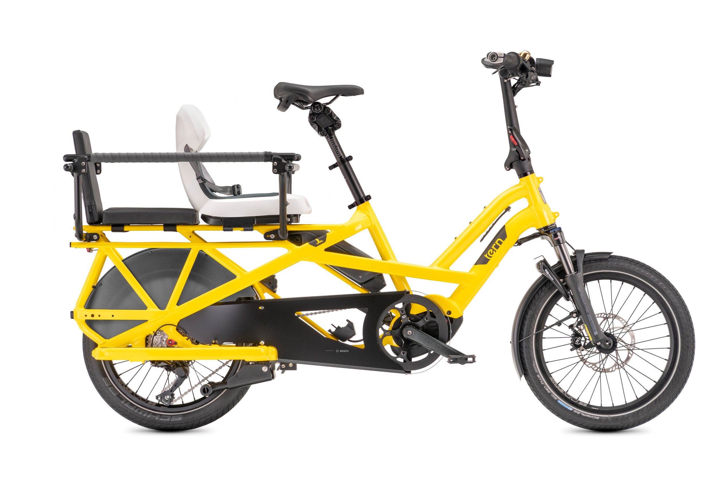 Yellow cargo bike with a child seat on a white background with a Tern clubhouse railing for cargo bicycles