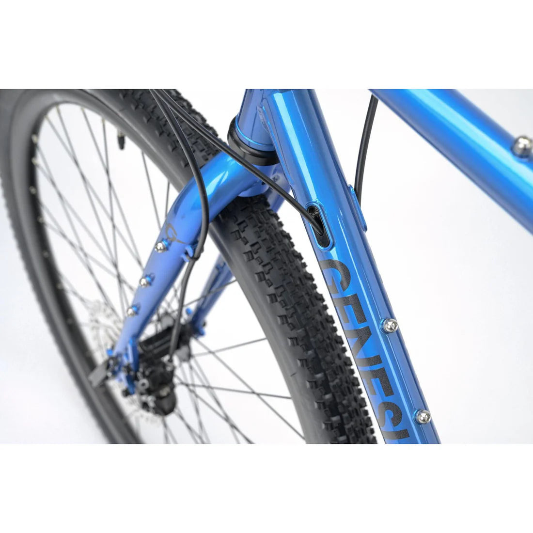 Close up of a blue bicycle frame with Genesis written on a white background