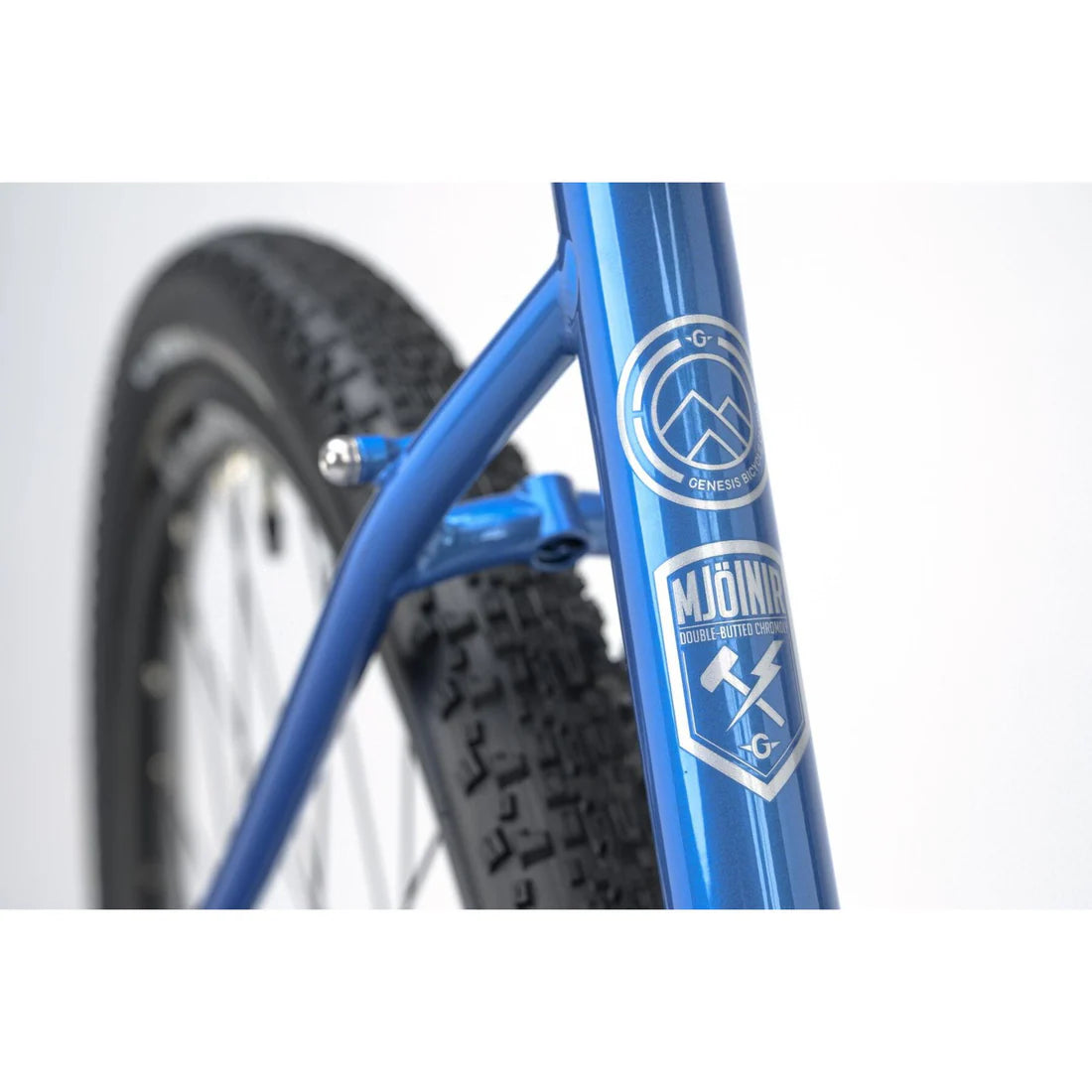 Close up of a bicycle blue frame with Genesis logo