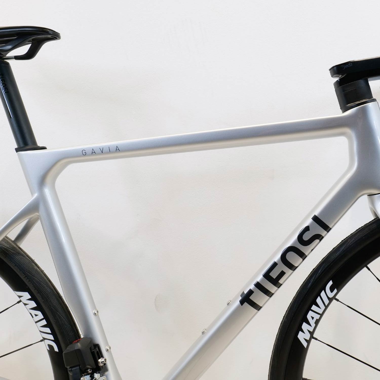 Silver bicycle frame with Tifosi branding and a Gavia name on it on a white background