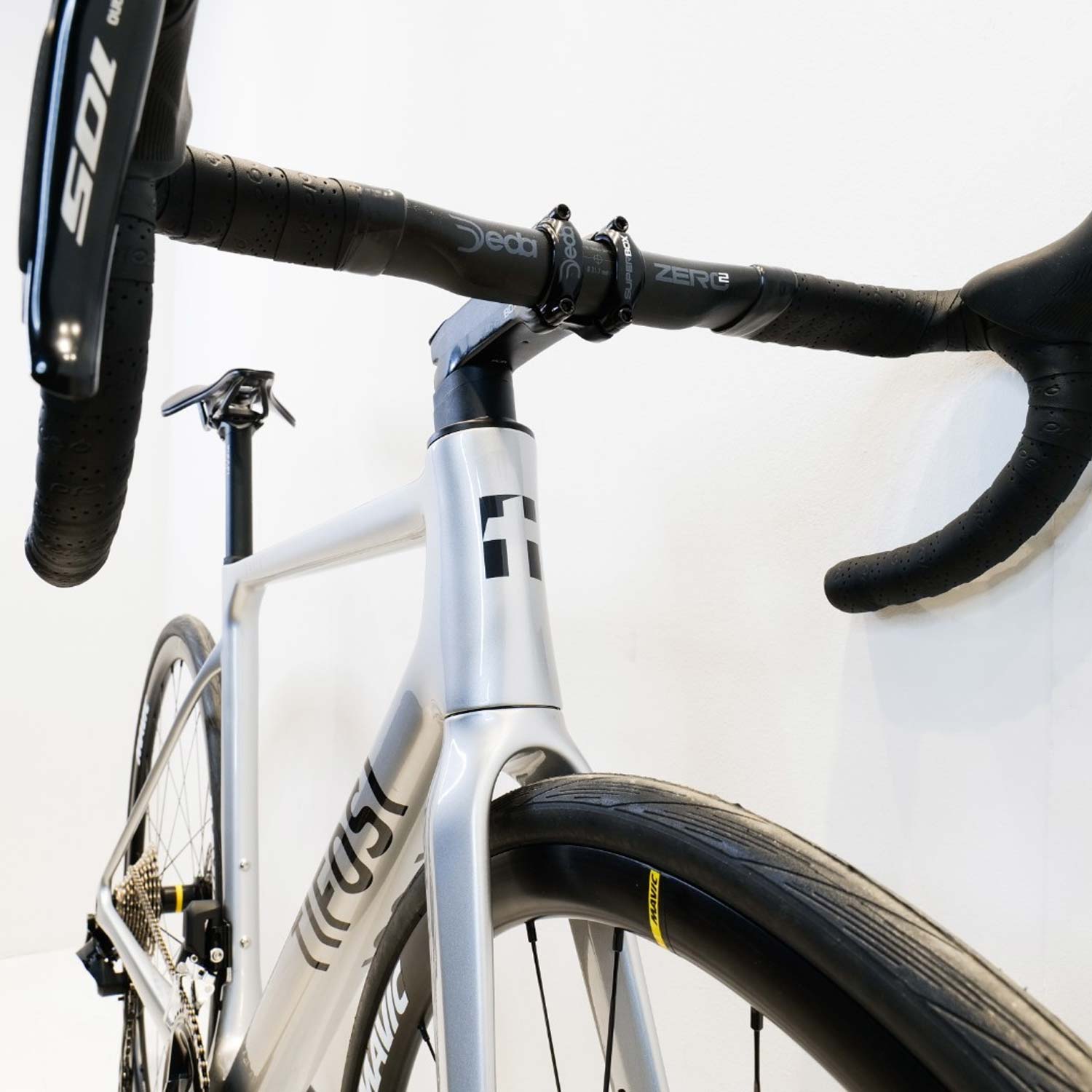 Silver bicycle with a black handlebar on a white background