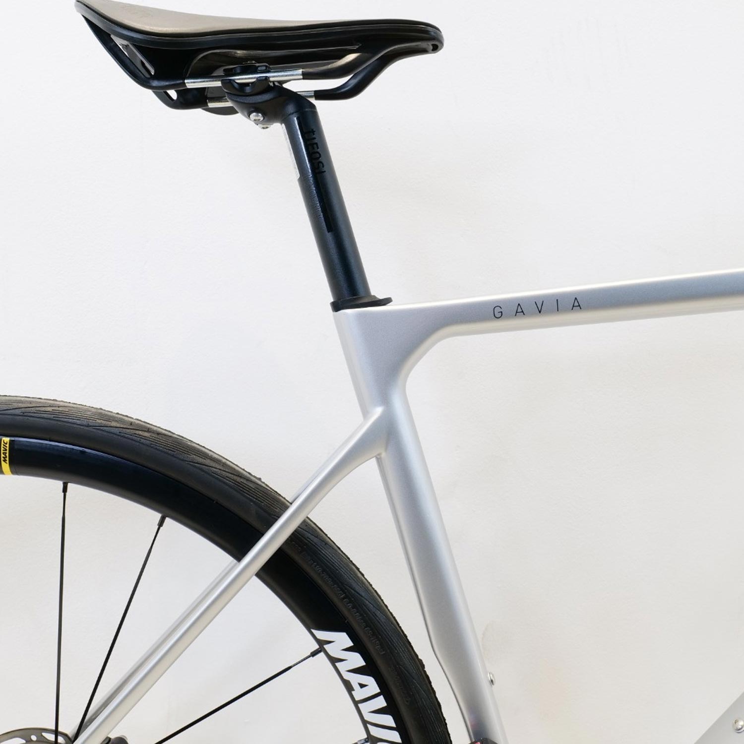 Close up of a silver bike frame with Gavia name on it on a white background